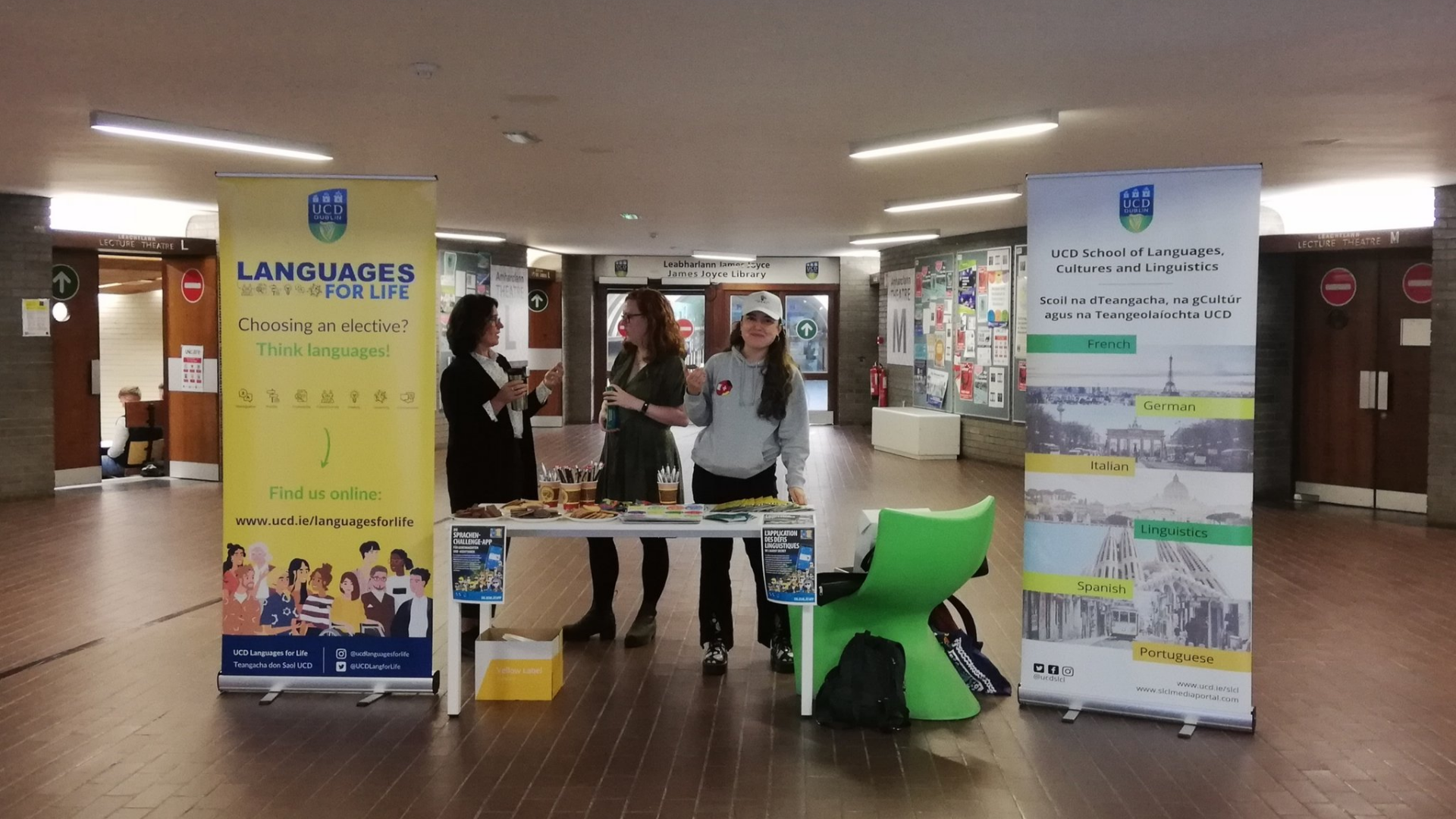 Staff and students at table with banners next and right